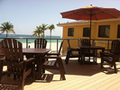 Deck with Chairs, tables and sun umbrella.